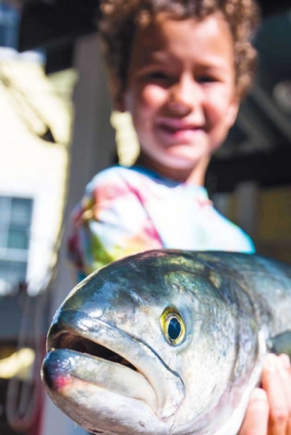 John Lee's son Charlie with a fresh-caught bluefish. 