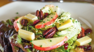 Boston Bibb salad made with spiced pecans and a vinaigrette with fresh apple cider