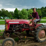 Diana Kushner driving her Farmall Cub at her farm, Arcadian Fields, in spring 2013.
