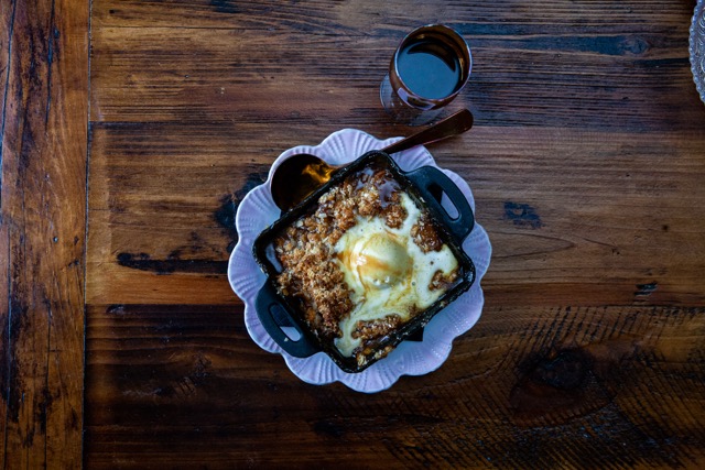 apple crisp with vanilla ice cream served in a white and blue bowl